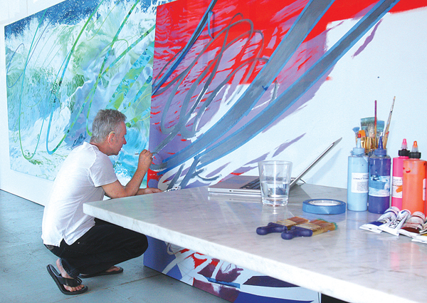 Photo by Barbaraellen Koch | Jamesport artist Charles Wildbank at work on 'Hot Wave,' a painting from a previous exhibit.