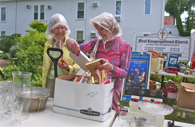 Photo by Barbaraellen Koch | Anila Kobylenski and Irene Pendzick sort through some books at the "Junktique' sale in Riverhead.