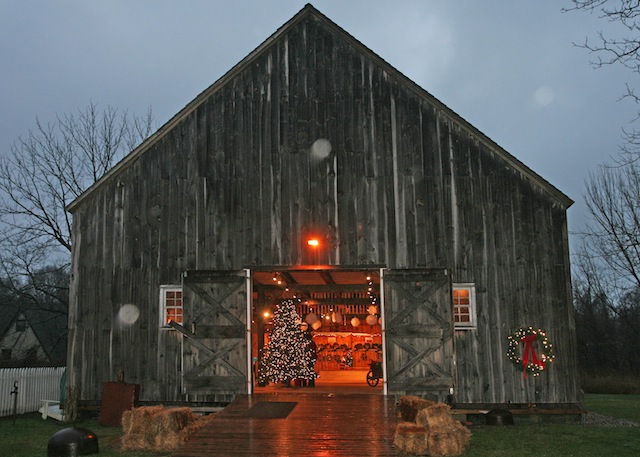 Photo by Beverlea Walz | The season of light beams out brilliantly to a December dusk at the Historical Society’s Havens House Barn.