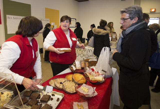 KATHARINE SCHROEDER PHOTO  |  Amy Mandala, center, with mom Judy sell treats from their Delicious Delights Bakery to Alan Gabay of Greenport.