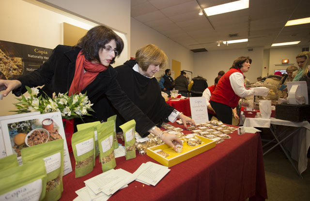 KATHARINE SCHROEDER PHOTO  |  Lucy Cascio, left, and Grace Longinetti rush to restock their samples at Copia Granola's booth.