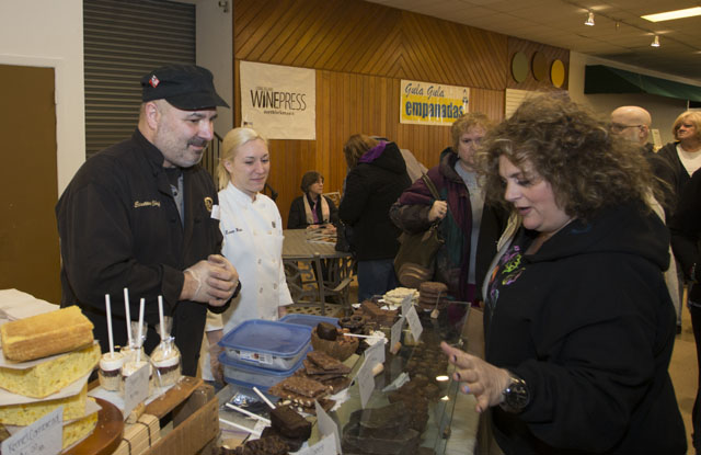 KATHARINE SCHROEDER PHOTO  |  North Fork Chocolate's Steve Emeril, left, and Lauren Woods, center sell treats to Marisa Charles of Riverhead.
