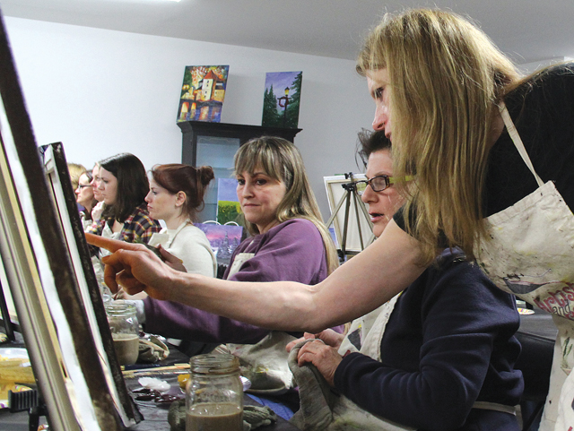 CARRIE MILLER PHOTO | Rita Rooney provides the artists in training with one-on-one help.