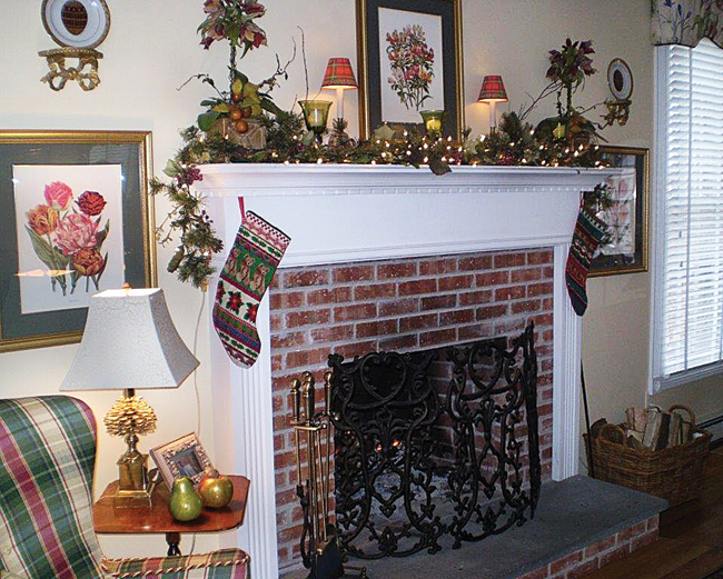 Infuse your mantel with holiday spirit by adding seasonal touches like holly and Christmas stockings. (Credit: Cindy Schmidt)