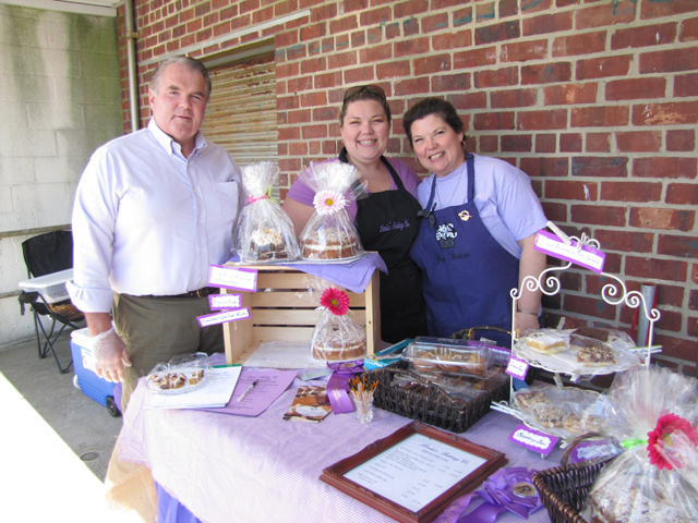 From left are Emmett Carey, Linda Carey and daughter Meghan Boch of Linda's Baking Company at the Riverhead Farmers Market Saturday. (Credit: Tim Gannon)