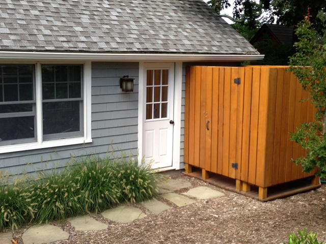 The cedar outdoor shower at Scott Schulman's in Southold is conveniently located next to the pool house, near the pool and hot tub.