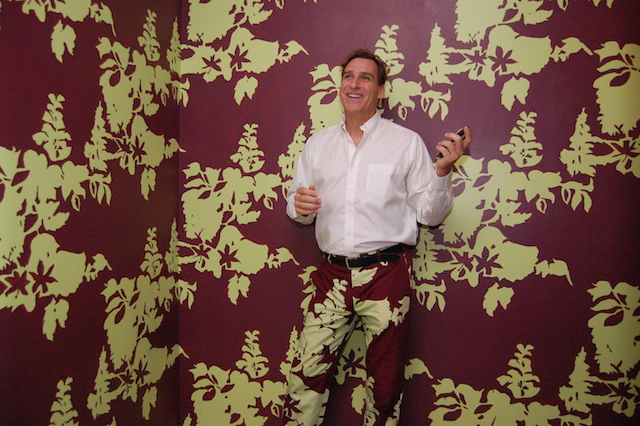 Dennis McDermott wears pants to match the wallpaper inside the downtown Riverhead eatery. (Credit: Vera Chinese)