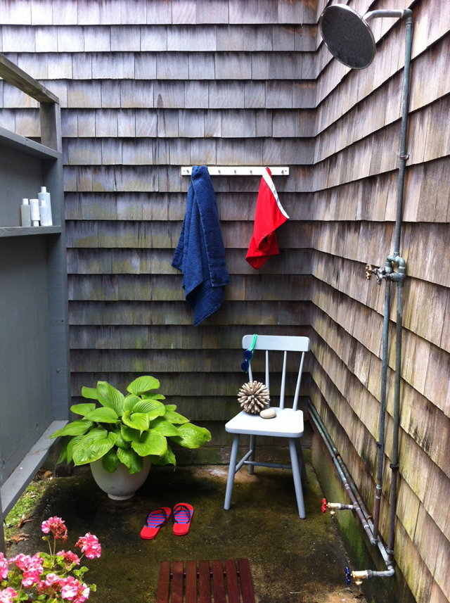 Jon Tomlinson's inviting outdoor shower in Mattituck, complete with chair, plants, hooks and a shelf.