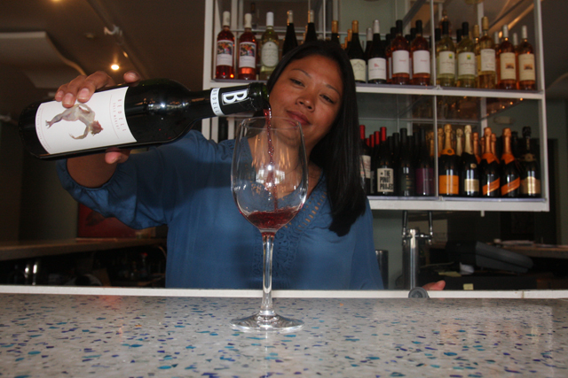 Sunita Schwartz pours a glass of red. (Credit: Barbaraellen Koch)