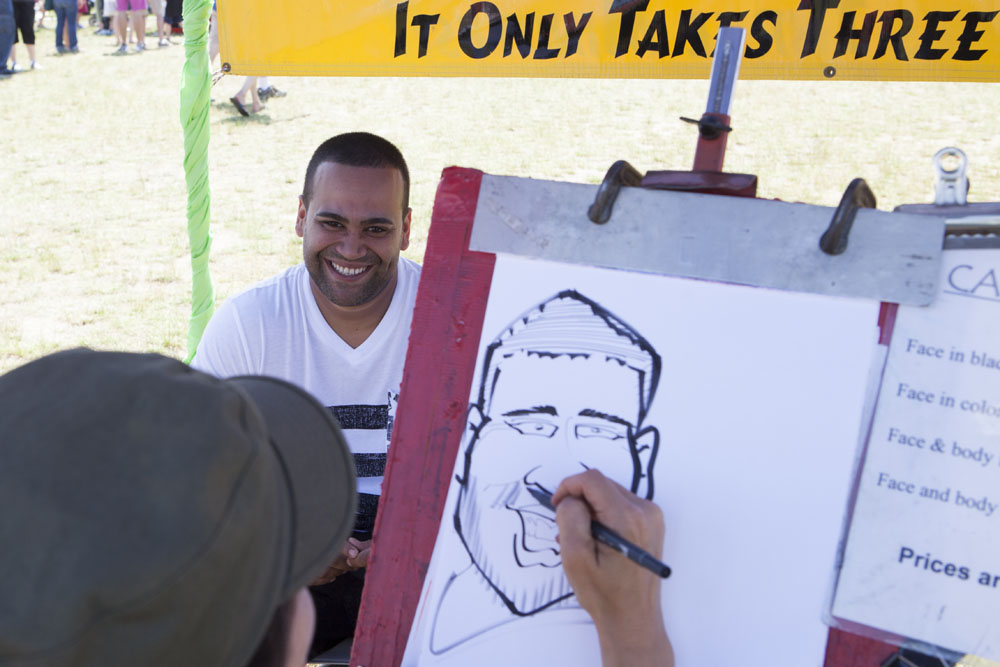 A man has his caricature drawn. (Credit: Katharine Schroeder)