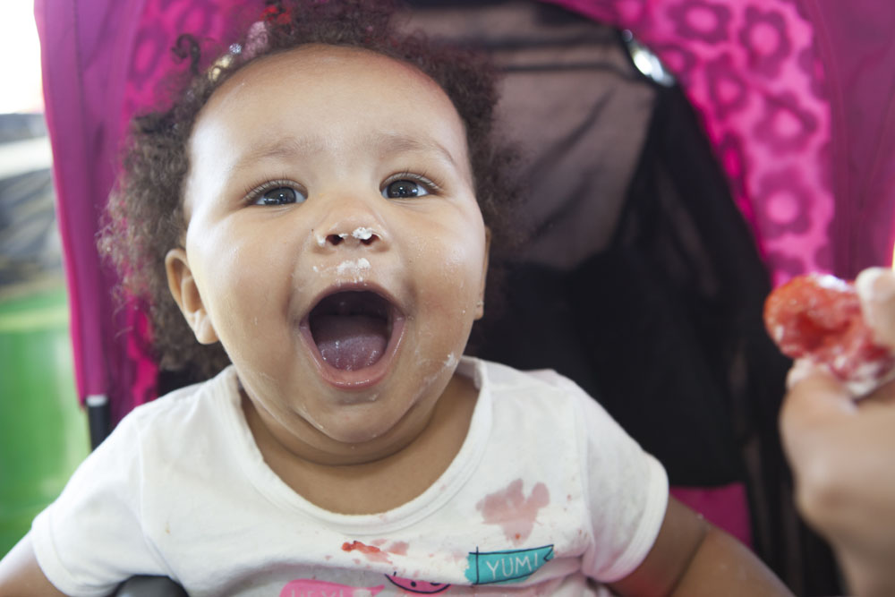 One-year-old Daisy Lawrence of Rocky Point can't wait to eat more strawberries. (Credit: Katharine Schroeder)