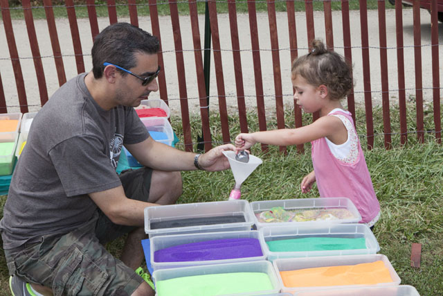Kayla Grochow, 4, of Melville, creates a sand sculpture with help from dad David.
