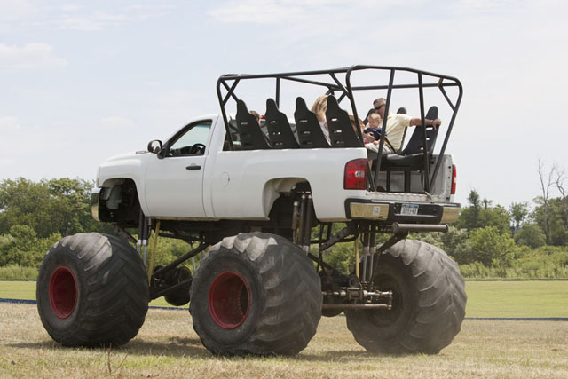 Monster truck rides through the farm fields.