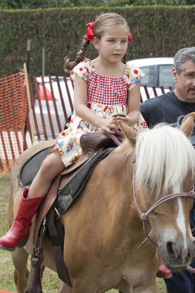  Emma Simon, 7, of Port Jefferson, takes a ride on a pony.