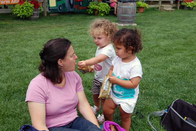 Daniella and Emma Ziering feed Elana Sydney a potato chip.