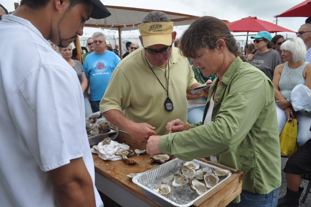 Tony Avila of Claudio’s Clam Bar looks on as the judges inspect the oysters