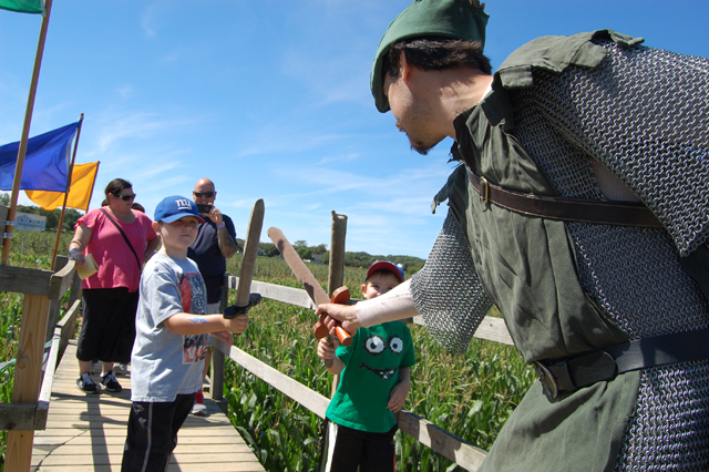Liam McCloskey, 8, of Massapequa battles Greg Lane dressed as Robin Hood.