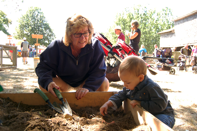 Debbie Lopez and grandson Liam Savage, 2, both of East Islip dig for fake potatoes.