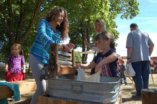 Kelsey Wilson, 11, of East Moriches and her cousin Kaitlyn Eckles, 4, of Manorville get a taste of farm life.