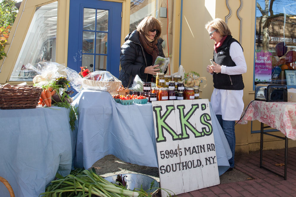 Karen Danzer of KK's Farm in Southold helps Rosemary Batcheller of Mattituck with a purchase