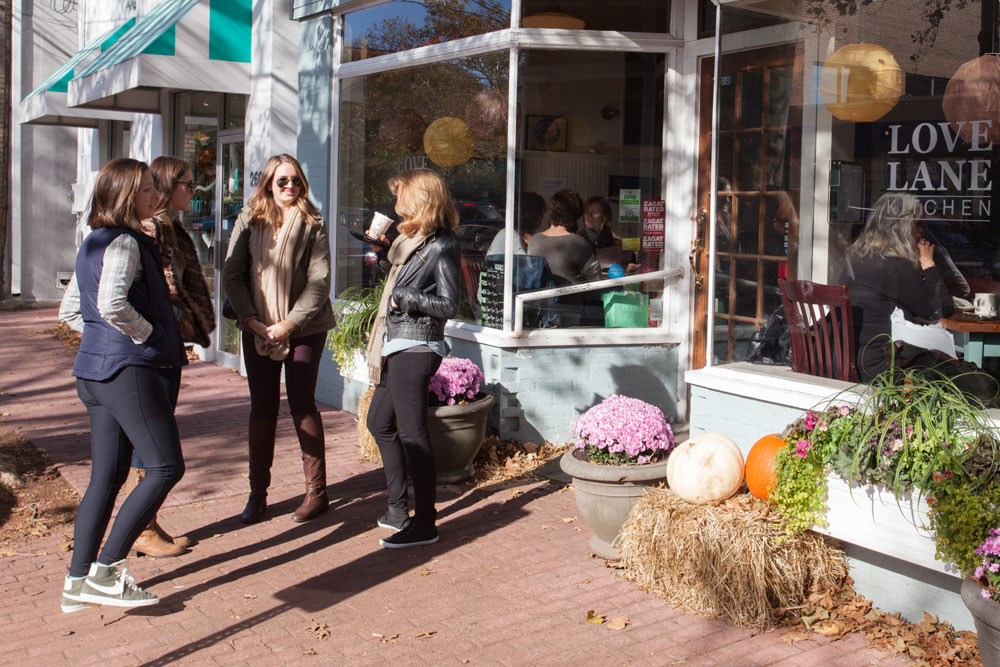 A group of friends waits for a table outside Love Lane Market.