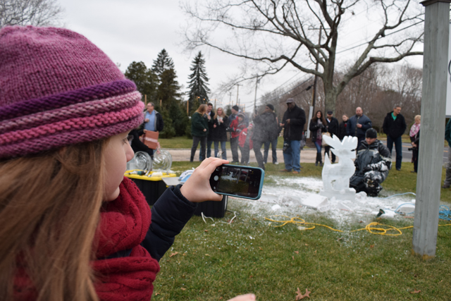 Kalea Tepedino, 6, of East Moriches snaps of photo of Rich Daly.