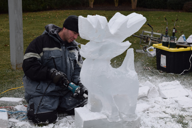 Daly carves an ice reindeer.