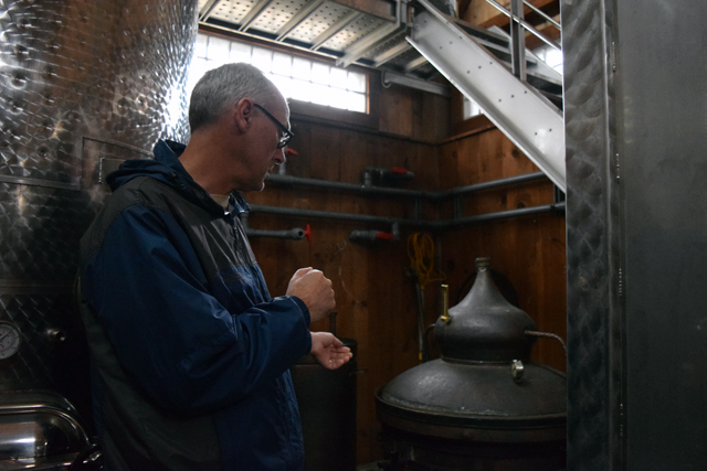 David Page shows off the still at Shinn Estate Vineyard.