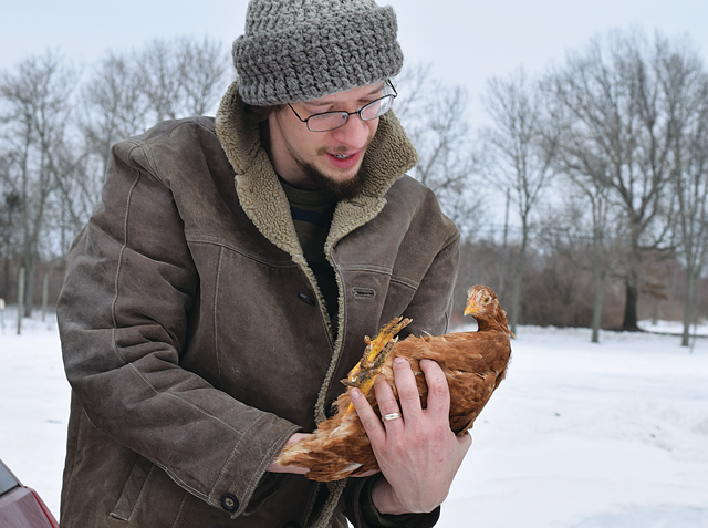 Jared Jeanotte of From Scratch Farm holds one of his chickens. (Credit: Vera Chinese)