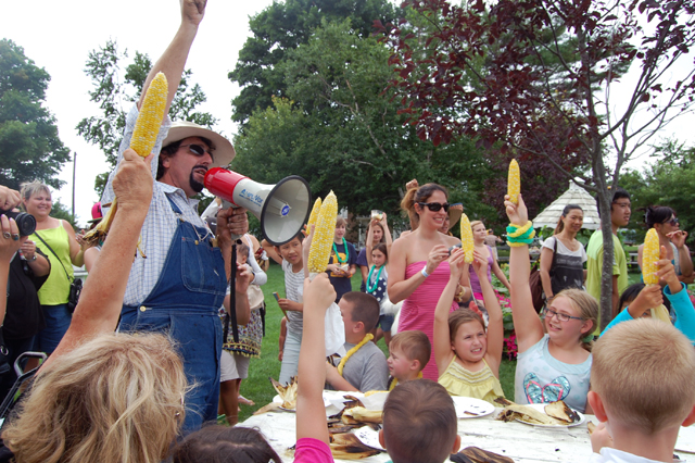 Farm Fred leads the corn on the cob eating contest at Harbes.