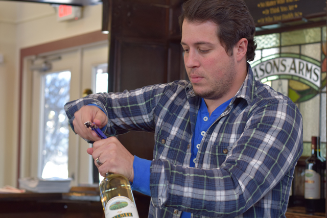 Ken Cereola opens a bottle of Palmer Vineyards 2014 sauvignon blanc.