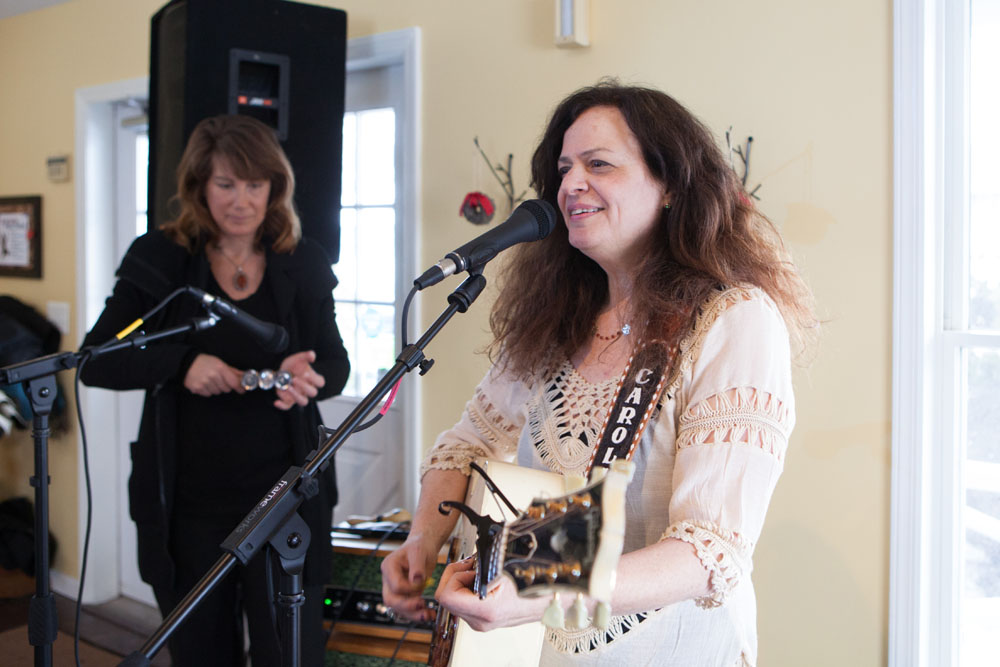 Caroline Doctoro plays guitar backed up by Jean Schroeder on percussion.