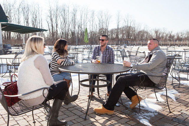 From left, Nancy Osback, Jorita Dundon, Alan Risola and Keith Osback of North Massapequa enjoy the sunshine outside Duck Walk Vineyards.