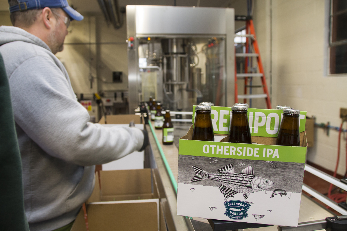 Greenport Harbor Brewing Co. brewmaster Joe Hayes sorts bottles Wednesday of the company's first batch of Otherside IPA, their first bottled beers. (Credit: Paul Squire)