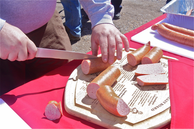 Greg Meyers of Wading River cuts up some kielbasa to put on the grill.