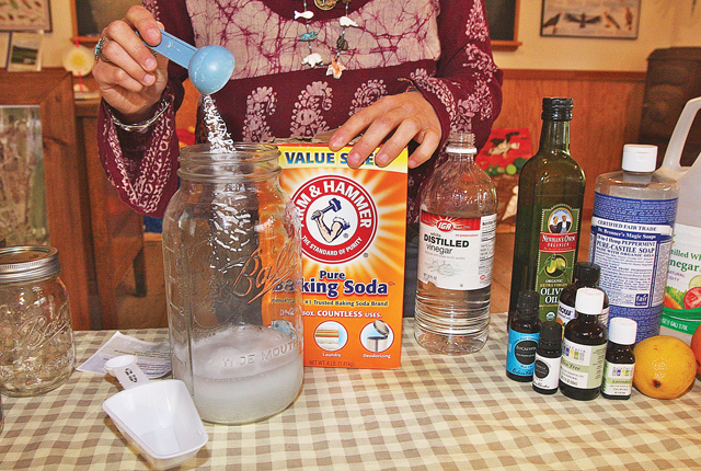 Making the all-purpose cleanser adding baking soda to the white vinegar. (Credit: Barbaraellen Koch)