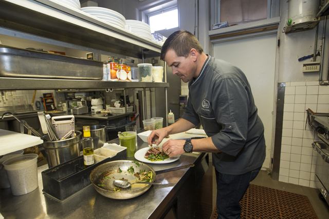Chef Robby Beaver plates the dish. (Credit: Randee Daddona)