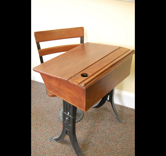 A refinished antique school desk.