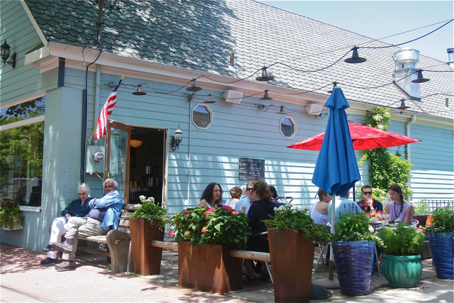 Bays, a four-month old Golden Retreiver, gets curious about what's for lunch as his owners Jim and Sue Given of New Suffolk get their sandwich on the sidewalk outside Lombardi's Love Lane Market Wednesday afternoon.
