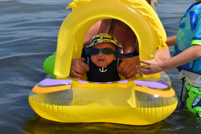 Luca Danza, 2 months of Holbrook, takes his very first dip in Peconic Bay. Little Luca, who was visting grandma Debbie Rensing in Jamesport, does not seem pleased. (Credit: Vera Chinese)