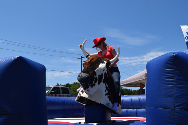 Marielle Tinari, 24, of Huntington rides the mechanical bull.