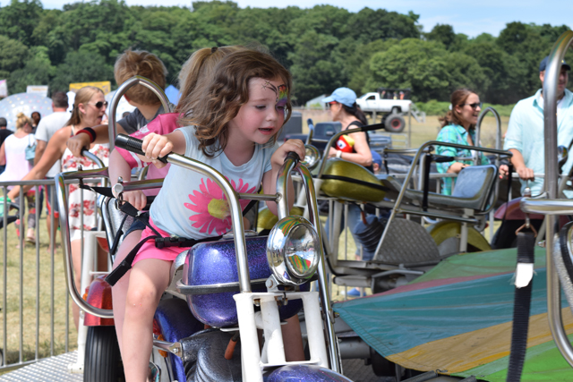 Sarah Smith, 3, of Mattituck takes a spin on one of the carnival rides.