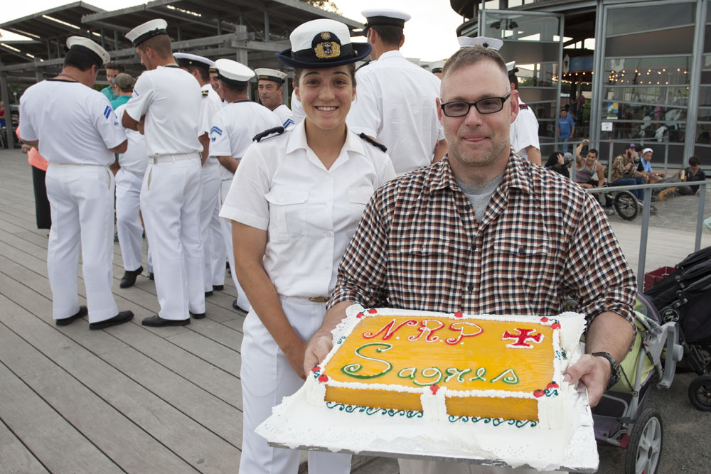 Ana Novais, Cadet Second Grade from the Sagres surprised Village Trustee Jack Martilotta with a cake the crew baked aboard the ship as a gift to Greenport Village.