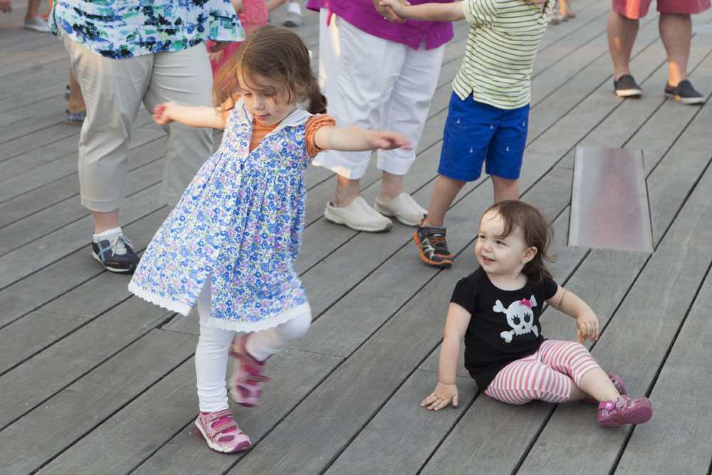 Moms dance with the kids.
