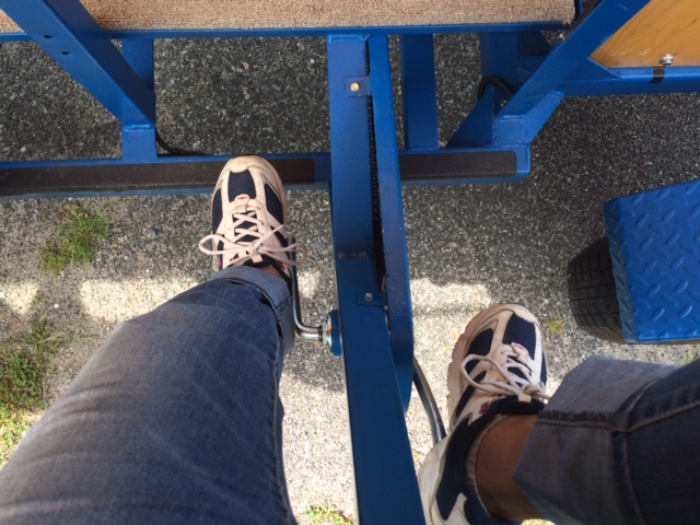 The author's feet as she pedals on the Brew Crew Cycle. (Credit: Monique Singh-Roy)