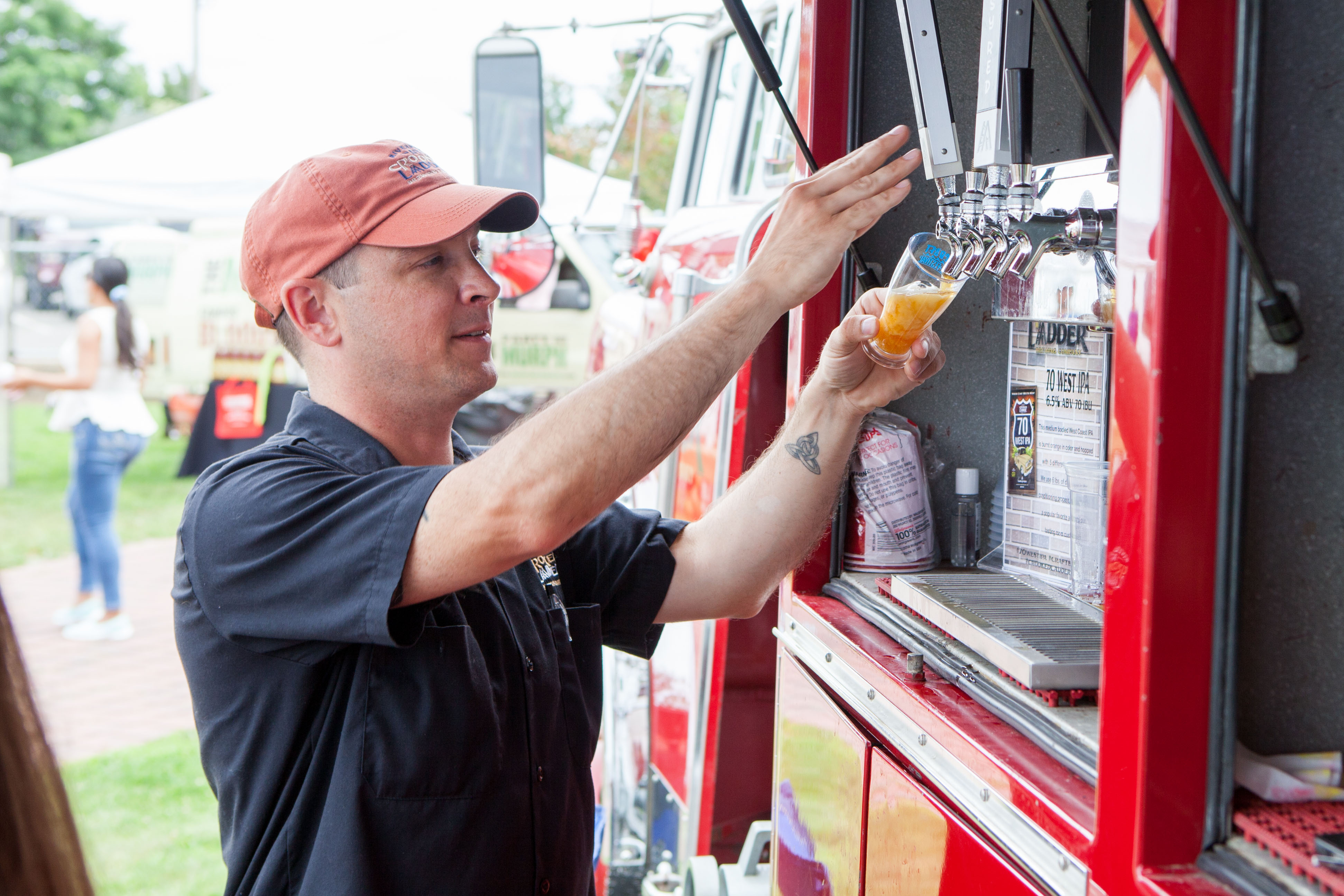 Nate Payne of Crooked Ladder pours a sample.