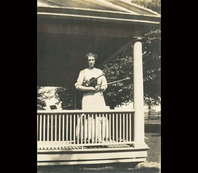 A 1930s photo of Ella Arminda Hallock with her violin on the homestead's front porch. (Credit: Hallockville Museum Farm, courtesy)