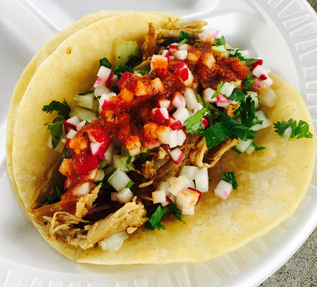Mexican-style tacos on a corn tortilla.