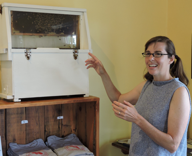 Beekeeper Laura Klahre shows off the hive at Coffee Pot Cellars. (Credit: )