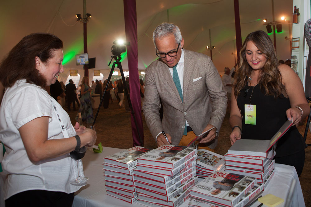 Geoffrey Zakarian signs one of 100 free books given out to guests.